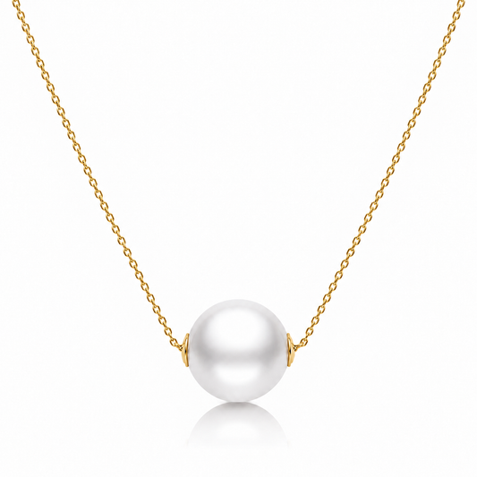 Gold freshwater pearl bead necklace with a single round white pearl on a white background