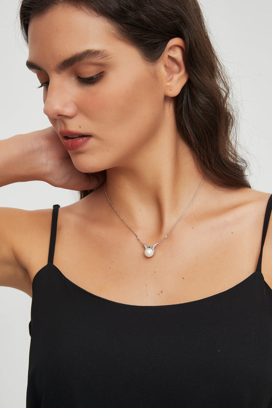 Model wearing the Sea Angel freshwater pearl pendant necklace in sterling silver with a black camisole.