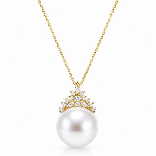 Gold freshwater pearl crown pendant necklace with clear accent stones on a white background