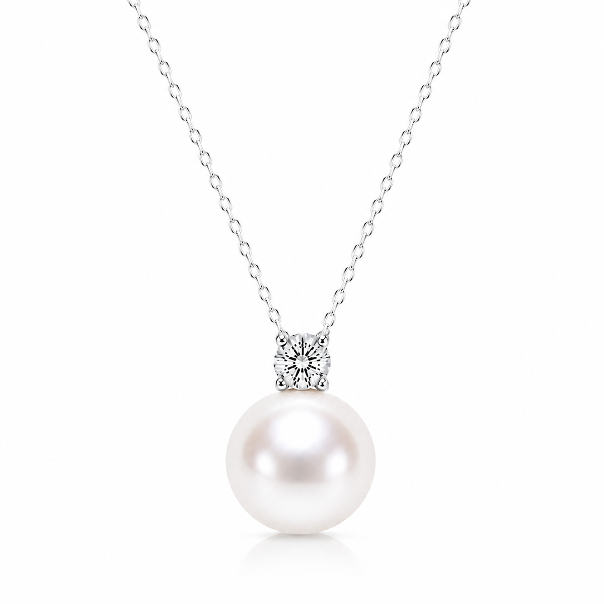 Freshwater pearl solitaire necklace with a four-prong cubic zirconia and silver-tone chain on a white background.