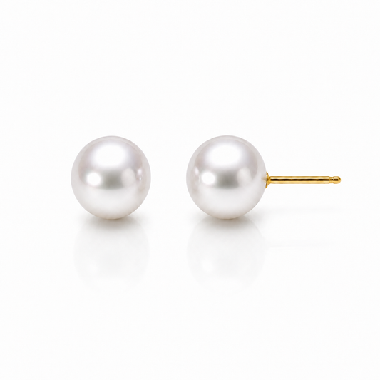 Freshwater pearl stud earrings with yellow gold posts on a white background