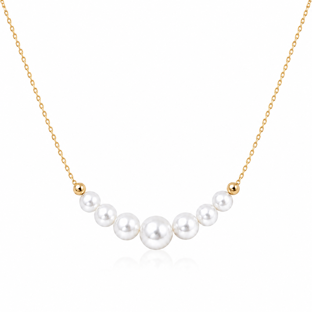 Gold-tone S925 sterling silver necklace with seven graduated round white freshwater pearls on a white background