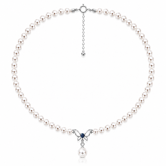 Freshwater pearl necklace with a sterling silver butterfly, blue cubic zirconia and pearl drop on a white background
