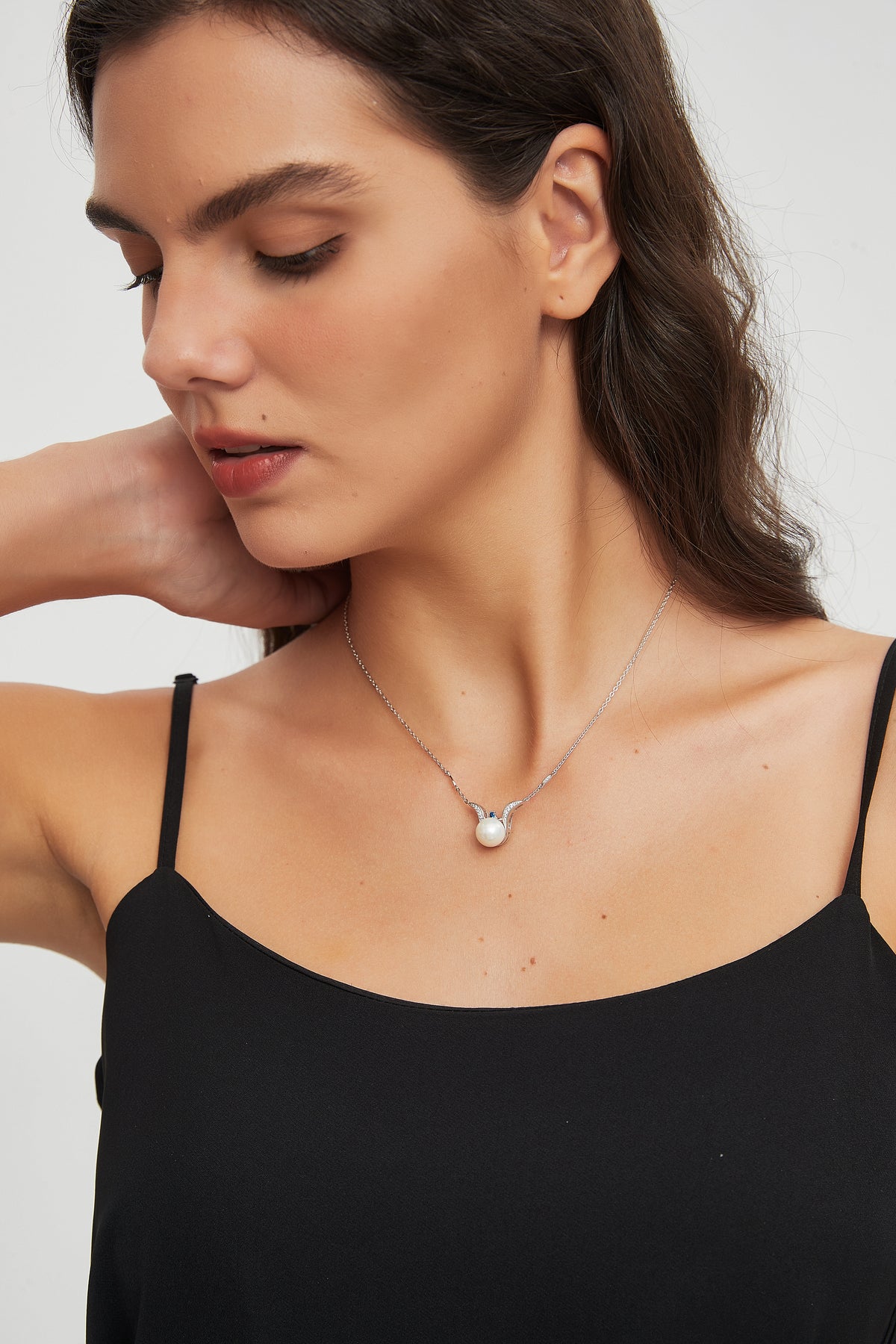 Model wearing the Sea Angel freshwater pearl pendant necklace in sterling silver with a black camisole.