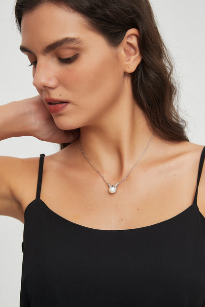 Model wearing the Sea Angel freshwater pearl pendant necklace in sterling silver with a black camisole.