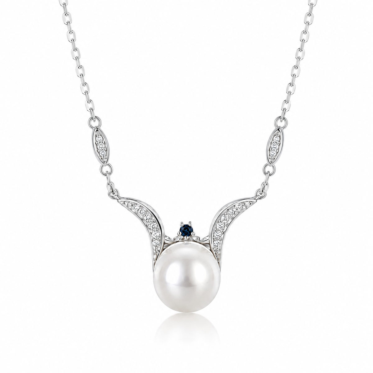 Sea Angel freshwater pearl pendant necklace in sterling silver with sweeping wing-shaped curves, cubic zirconia and a blue accent on a white background.