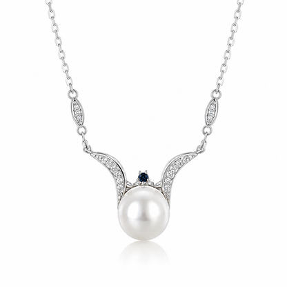 Sea Angel freshwater pearl pendant necklace in sterling silver with sweeping wing-shaped curves, cubic zirconia and a blue accent on a white background.
