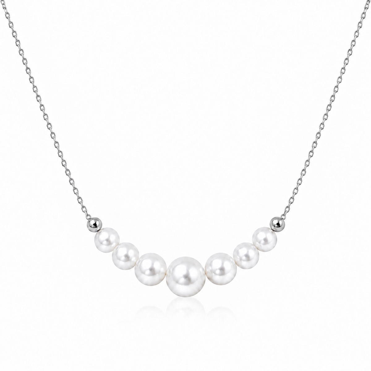 Silver S925 necklace with seven graduated round white freshwater pearls on a white background