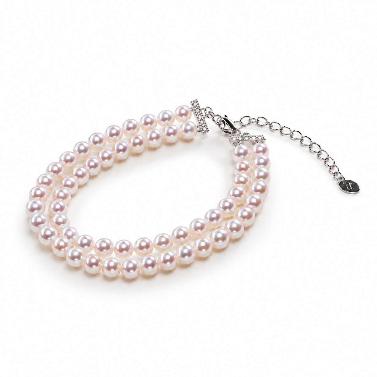 Double-row freshwater pearl bracelet with S925 silver clasp, extension chain and PERLAVELLE oval logo tag on white